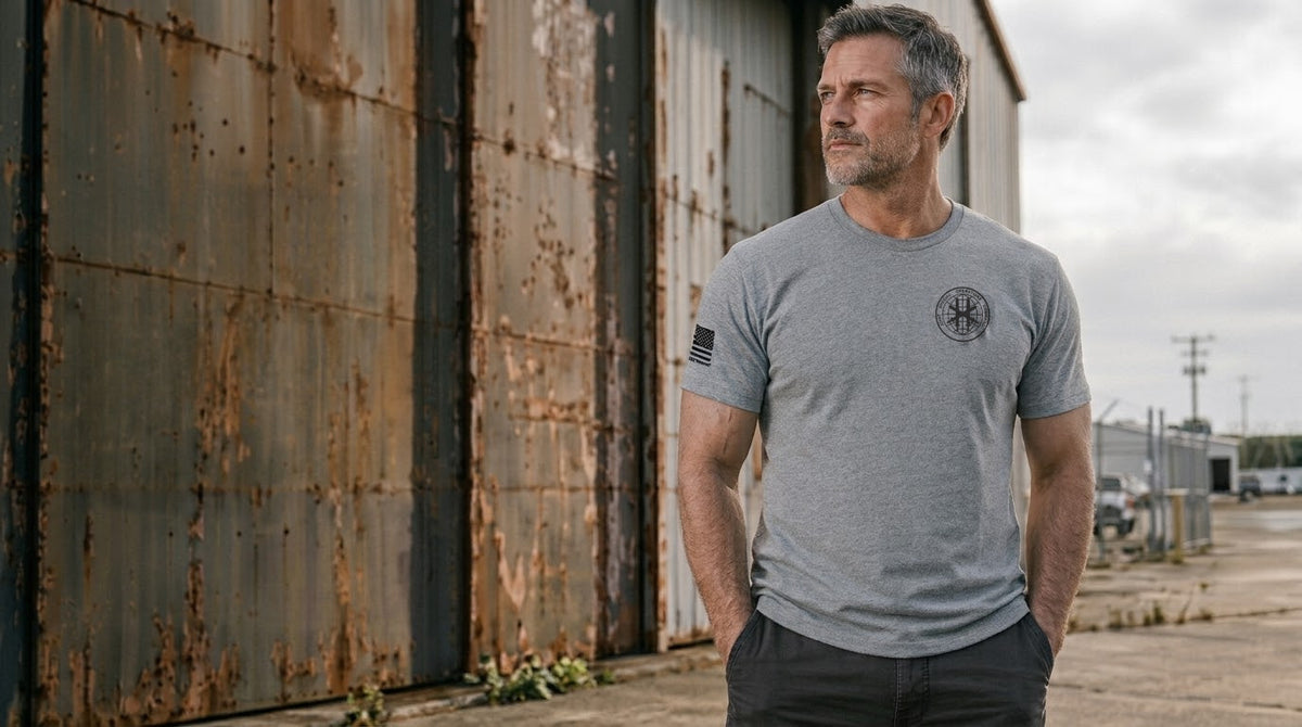 Campaign image: a man in the athletic grey JSOC Logo Triblend Tee outside a hangar