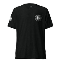 Solid black shirt, front view showing JSOC chest insignia.