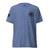 Blue shirt, front view showing JSOC chest insignia.