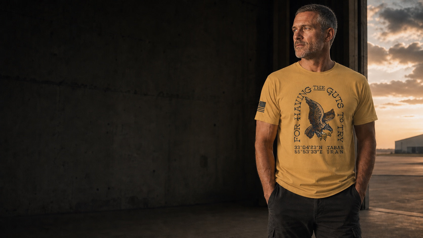 Mature man wearing the Guts to Try design at a hangar doorway — campaign illustration